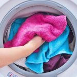 Putting laundry in the washing machine